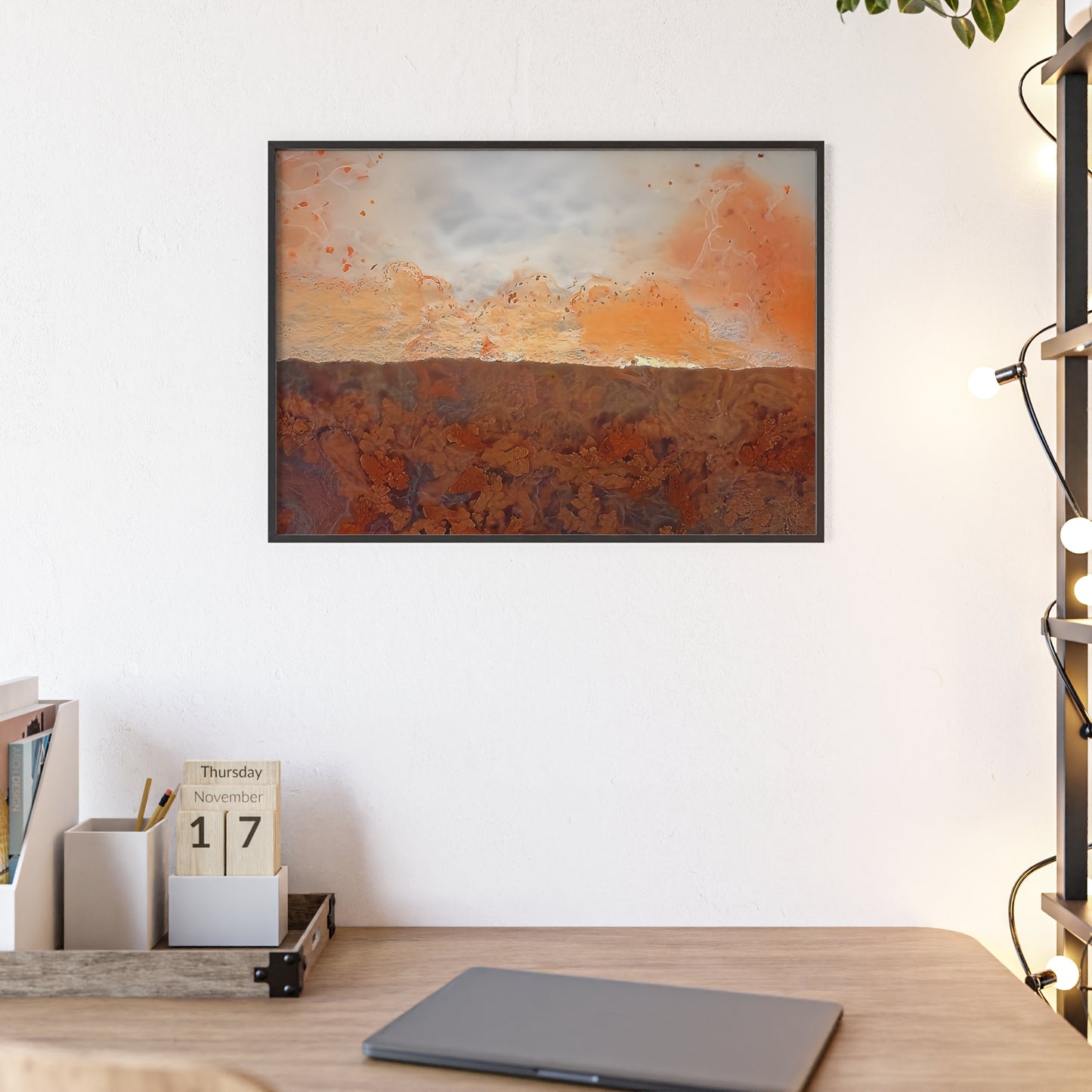 Rock art wall print featuring a plume agate with its vibrant orange, white and brown color The picture is in a black frame hanging above a desk in the bedroom of a home.