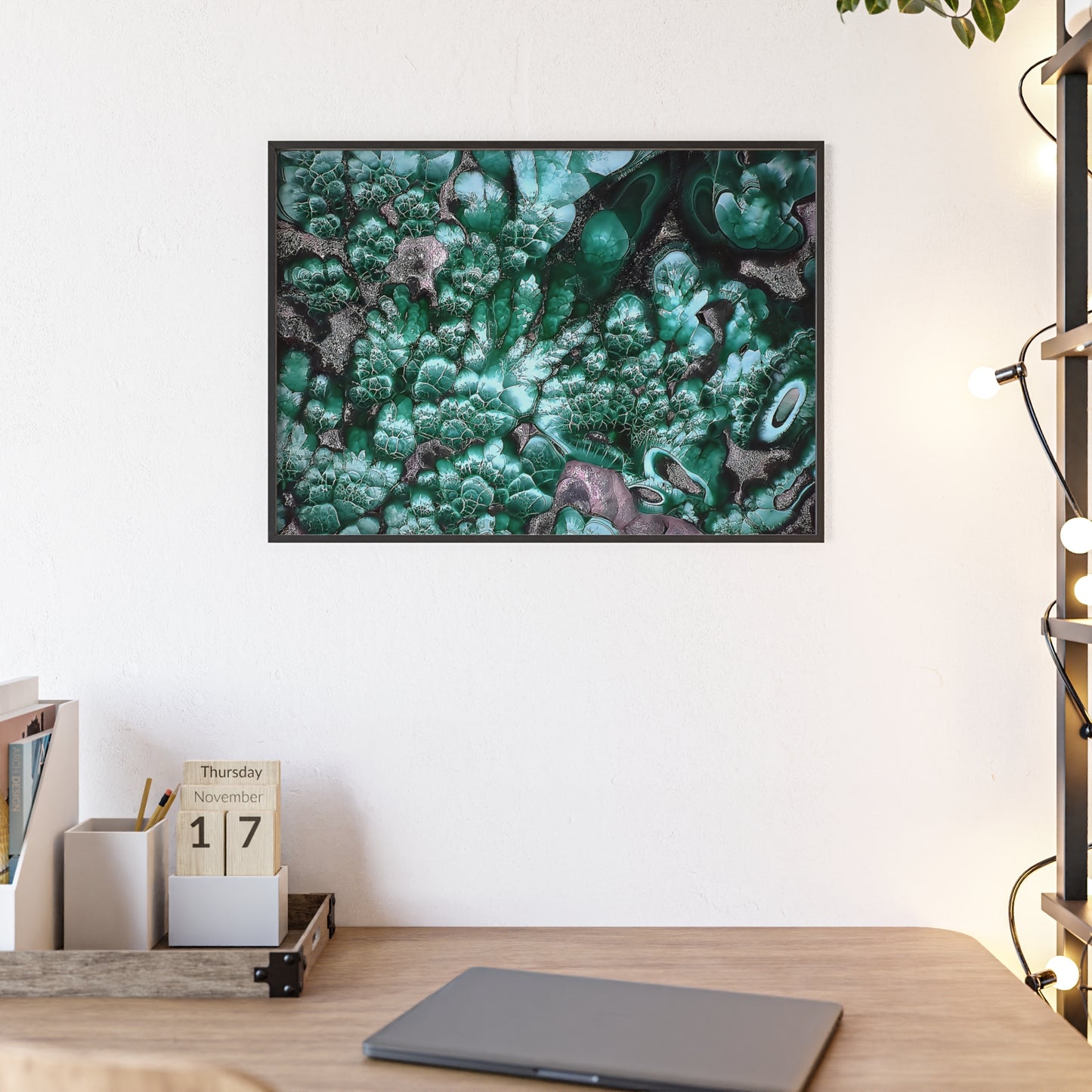 Rock art wall print featuring some  malachite with its vibrant green and gray color  The picture is in a black frame hanging above a desk in the bedroom of a home.