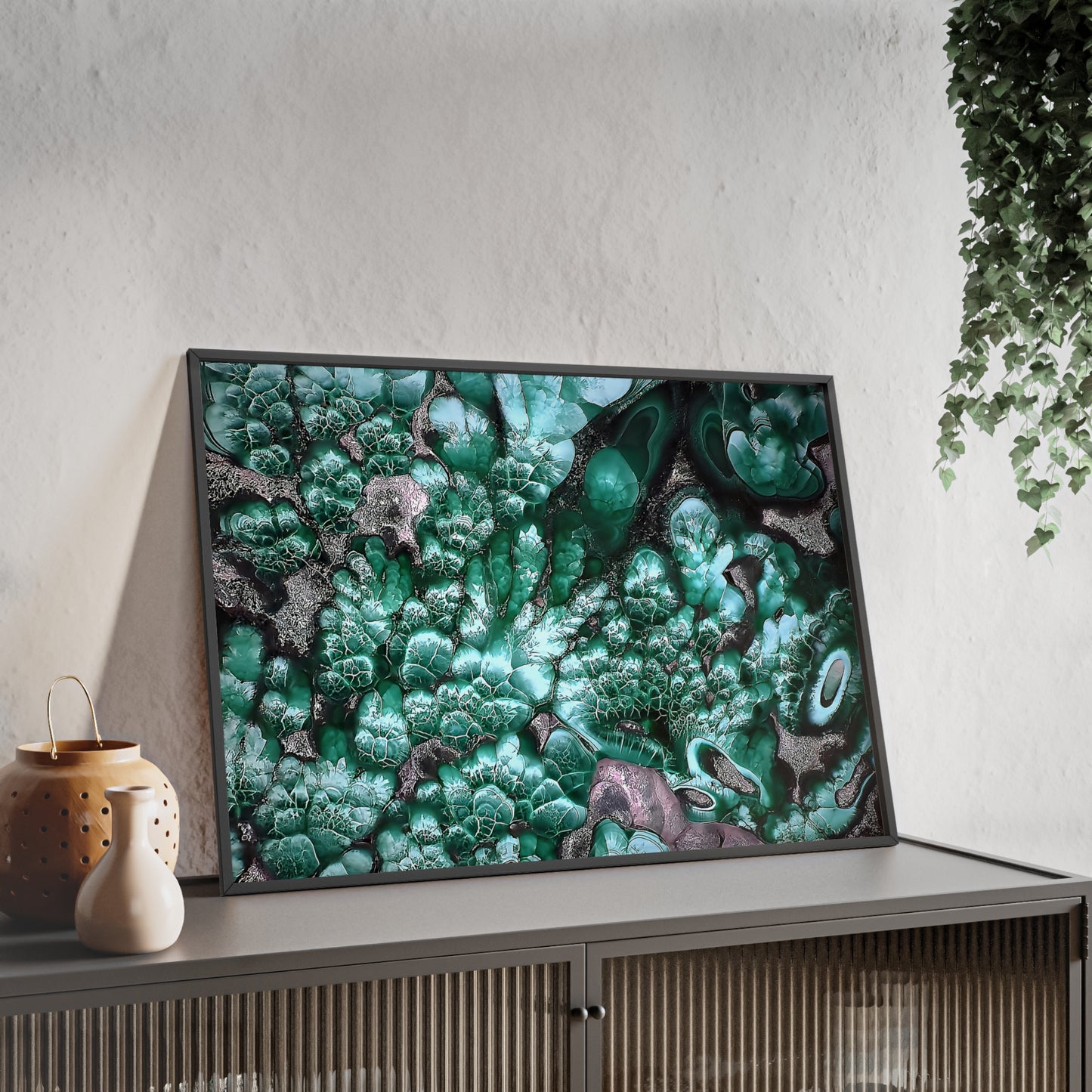 Wall art print capturing a captivating close-up photograph of malachite with its gray and green color. The picture is in a black frame and is leaning against the wall, on a low height cabinet, in the living room.