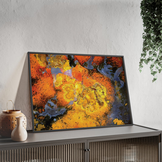 Wall art print capturing a captivating close-up photograph of a Polished Stromatolite Agate with its orange, white and black color. The picture is in a black frame and is leaning against the wall, on a low height cabinet, in the living room.