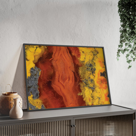Wall art print capturing a captivating close-up photograph of a seam agate with its red, yellow and gray color. The picture is in a black frame and is leaning against the wall, on a low height cabinet, in the living room.