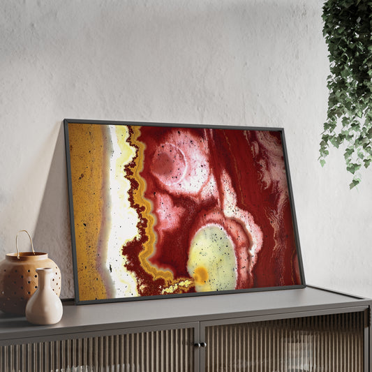 Wall art print capturing a captivating close-up photograph of some tiger iron with its red, yellow and white colors. The picture is in a black frame and is leaning against the wall, on a low height cabinet, in the living room.