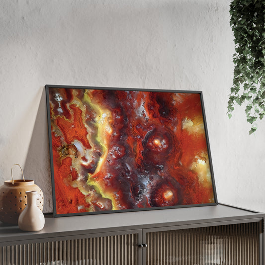
Wall art print capturing a captivating close-up photograph of a wildfire hyalite bubble opal with its red, orange and yellow colors. The picture is in a black frame and is leaning against the wall, on a low height cabinet, in the living room.